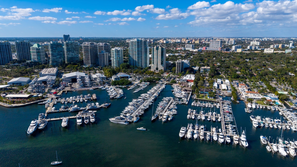 Aerial view of the Coconut Grove marina on Biscayne Bay with sailboats and bayfront condominiums