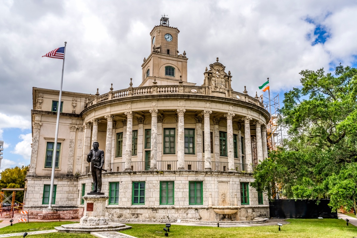Coral Gables City Hall, the 1927 limestone rotunda with clock tower and statue of George Merrick in front