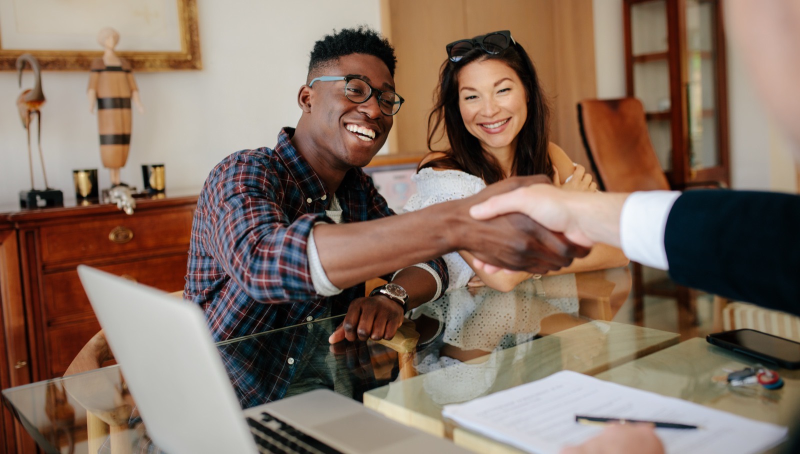 A Florida home buyer and seller shaking hands at a real estate closing